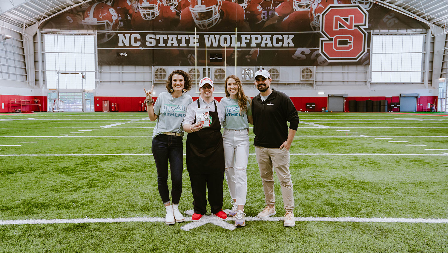 321 co-founders Michael Evans and Lindsay Wrege stand with employee Sam during the unveiling of their Greater Good coffee packaging.
