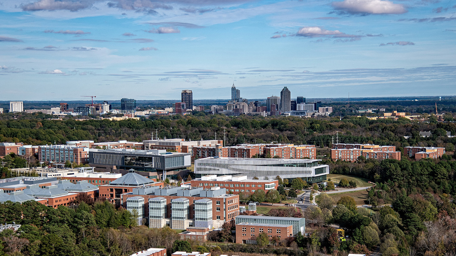 A view of NC State's Centennial Campus with the Downtown Raleigh skyline on the horizon.