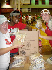 Volunteers packing bags of food in the Carmichael Gym during the Million Meals event