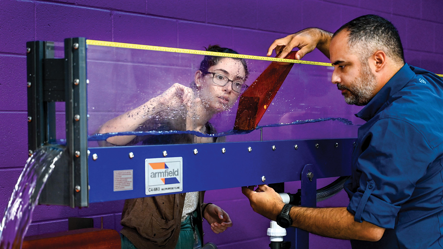Assitant Professor Tarek Aziz works with a student in the Hydraulics Lab in the Fitts-Woolard building on Centennial Campus.