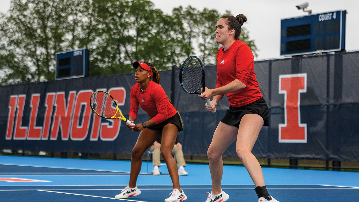 Two Wolfpack tennis players during a match.