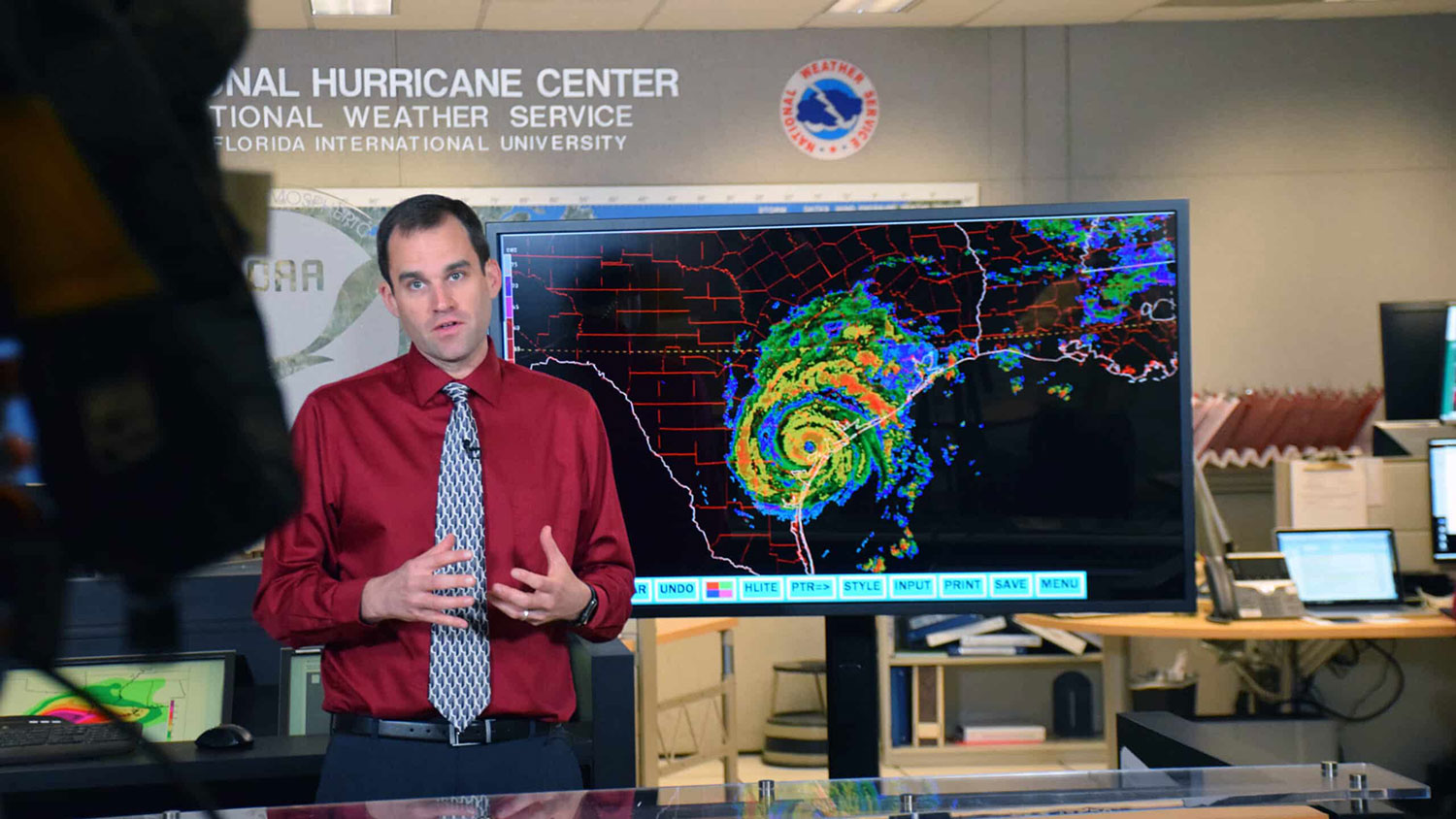 Michael Brennan speaks to a camera about a forecasted hurricane at the National Hurricane Center in Miami, Florida.