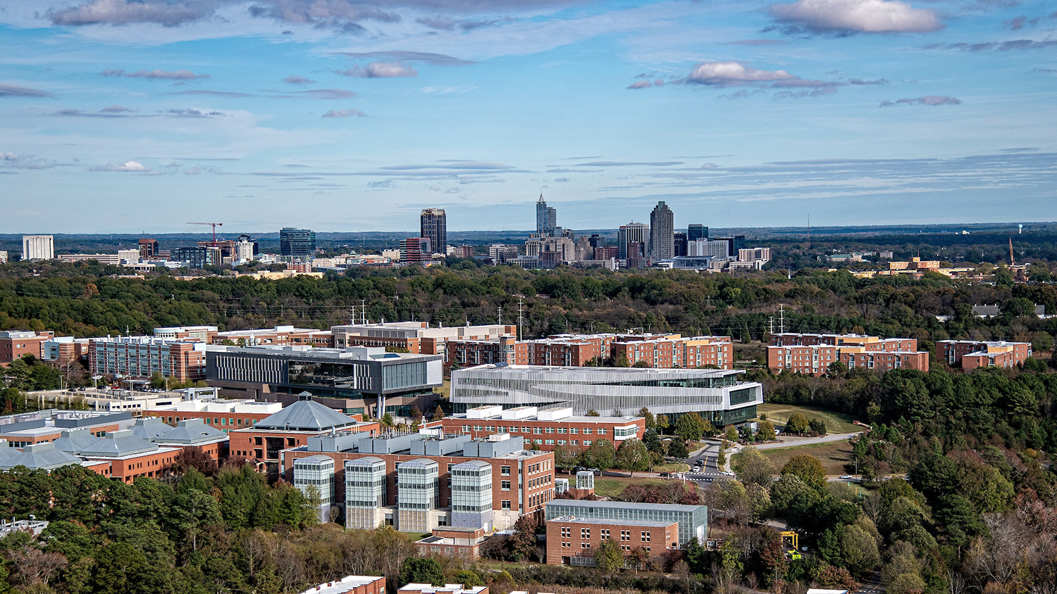 A view of NC State's Centennial Campus with the Downtown Raleigh skyline on the horizon.